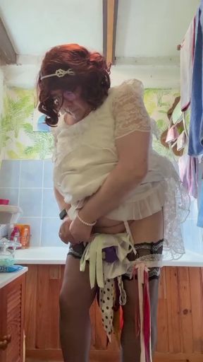 Dressed in a white lace dress to pee in a bottle
