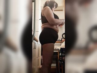 stepmother in large pants in the kitchen, with sexy movements
