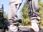 Very daring and very handsome boy plays with his bicycle in public