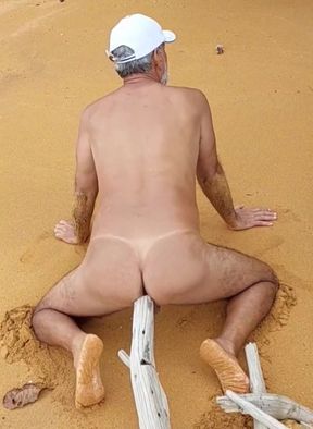 Naked ladysilva on the beach rubbing on big cock