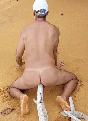 Naked ladysilva on the beach rubbing on big cock