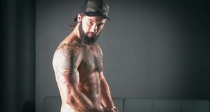 Solo guy with sexy beard jerks that dick until jizz begins to pop all over the couch