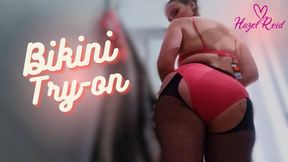 Hazel Reid tries on a pink bikini