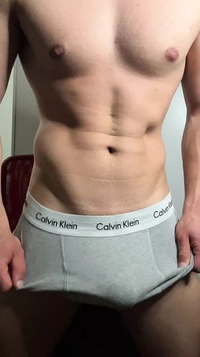 Young hunk strokes his cock in boxers and balaclava