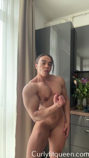 Naked female bodybuilder showing off her competition poses