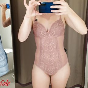 A girl with a perfect figure tries on different lingerie