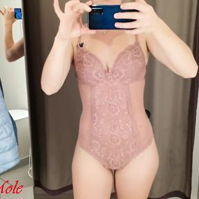 A girl with a perfect figure tries on different lingerie