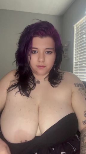Purple-haired woman in a black dress