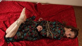 Anne: barefoot girl in flower dress, hogtied on the floor with hemp rope, wiggles and poses (HD WMV)