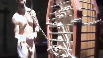 Blindfolded submissive Chet Walker endures heavy chain bondage and ball tugging