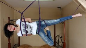 Ballgagged barefoot Ola in white t-shirt and blue jeans, suspended with violet hemp rope sideways, is tickled by camera man (HD WMV)
