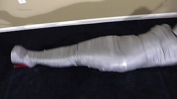 Tempting brunette secretary gets her entire body covered in duct tape, her boss had fun after hours