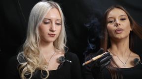 Two Women in Black Outfits Sharing a Cigarette with Slow Smoke and Playful Interaction