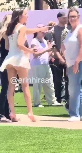 Blonde woman in white dress walking on grass