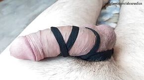 Teen tied his big cock with a shoelace and masturbates