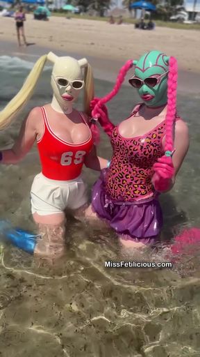 Latex-clad Lola Noir enjoys a sultry beach day with her friends