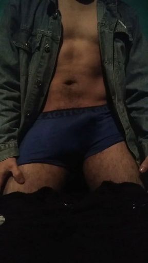 Latin man taking off his clothes