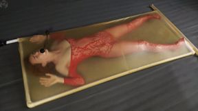 Red costume and pear gag in a latex bed