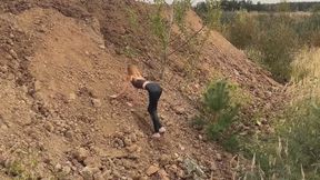 A girl in high-heeled shoes She tries to climb a steep slope, but she can't (short version)
