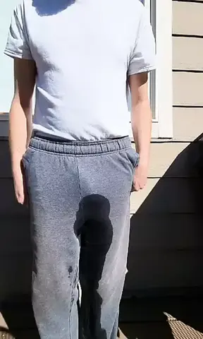 Sissy fag loser pees her pants outside.