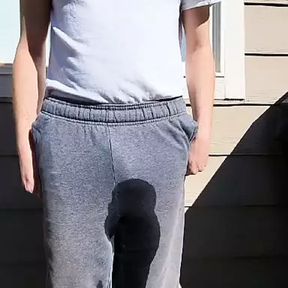 Sissy fag loser pees her pants outside.