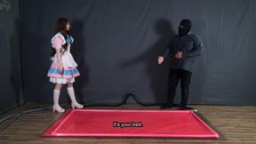 Tickle doll in a pink latex bed