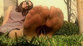 Stretching Toes And Arches In Pantyhose On Grass