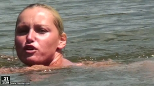 Kathia Nobili swimming naked at the water