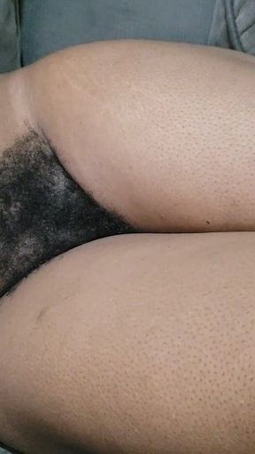 A Woman with Lots of Beautiful Pubic Hair Between Her Legs Lies on Her Sofa Waiting to Be Made Love to Her