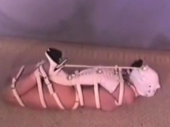 Hogtied Ashley struggling on the floor