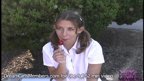 Curvy college girl in short skirt sucks lollipop while walking
