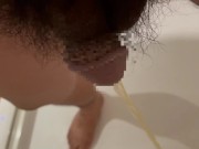 Chubby Japanese guy pees in the bathroom drain