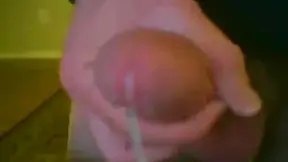 A guy jerking off and cumming on his hand filmed close up