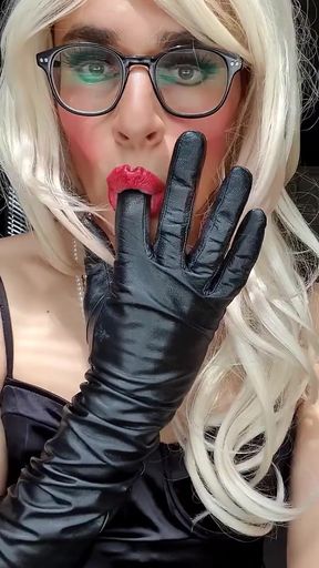 Teasing you in my black satin dress, full make up, pearls, opera leather gloves, stockings, suspenders, pearls, chastity, blonde