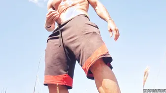 Muscular Latino twink strokes his big uncut cock on a public beach