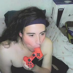 Cute cd girl, beautiful eyes and face. Kissing, licking and sucking a playstation controller. Sweet cd girl next door.