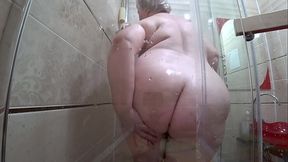 Appetizing Russian MILF washes in the shower and her fat body with huge