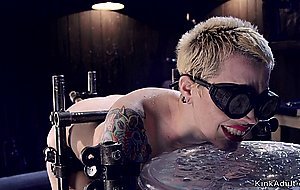 Short hair blonde in device bondage