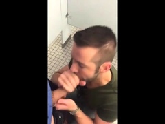 Handsome guy sucks dick in restroom stall