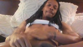 Dreadlocked Guy Lies in Bed and Massages His Manhood