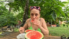 Watermelon Muncher - GLIMMER in a bikini eats an entire watermelon and gets sticky, with fruit, mouth, overeating, slurping, small tits, shaved head, sunglasses, outdoors