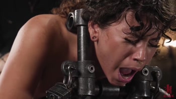 Curly Brunette Locked in Iron Frame and Spanked