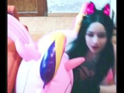 Cosplay girl has fun with a pink inflatable unicorn