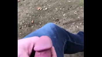 Gnan touching cock on bench in wooded trail