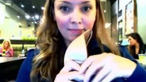 Charming chick takes her bra off in a public place