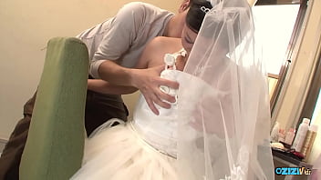 The new asian wife is still dressed in her wedding gown when someone visited her