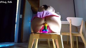 Pretty babe in a cute pink skirt rides her rainbow cock and has an orgasm!