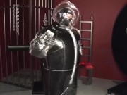 Blonde girl in black latex catsuit full encased in inflatable rubber and full body plastic suit