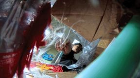 MARTINA throwing garbage into the garbage bag POV