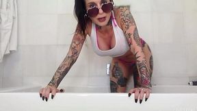 Tattooed milf Joanna Angel is playing with anal plug and vibrator in the bathroom